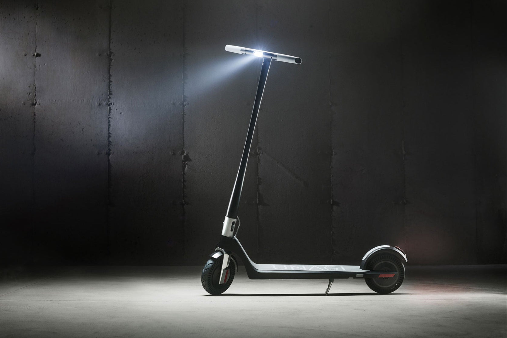 Electric scooter with a light on a dark background